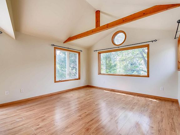 Master suite with picture windows and vaulted ceiling.