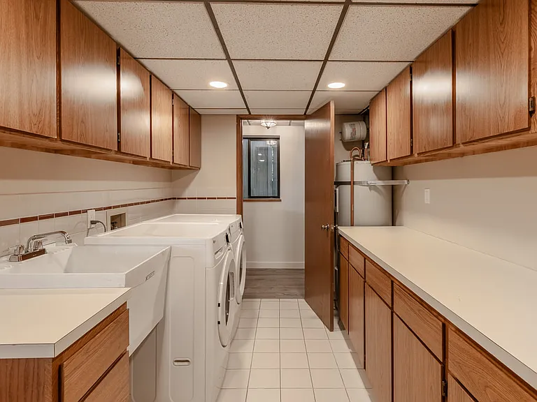 Private laundry suite with plenty of storage