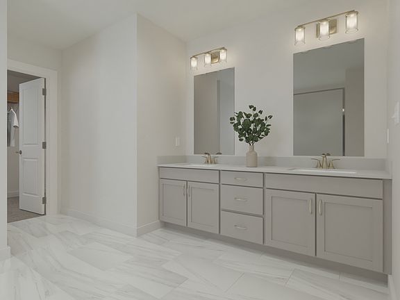 The primary bathroom offers dual vanity sinks and a walk-in shower.