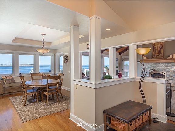 On our left is the dining room...VIEWS are Everywhere!  Moabi hardwood flooring (African Pearwood) in this main area and down hall.