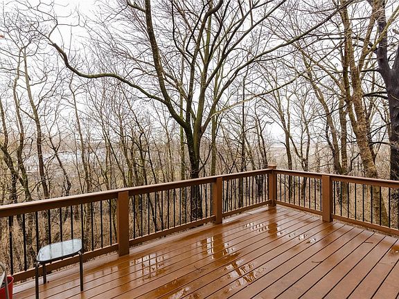 Newer composite deck overlooks private, wooded common ground.