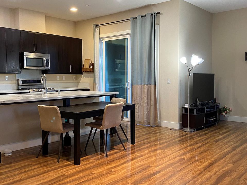 living room with kitchen and minibar, wood floor