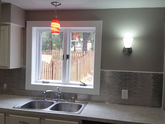 Kitchen looks into Backyard