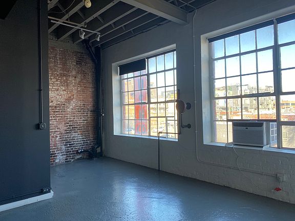 Front Windows in the loft. Opie Brush sign out the window.