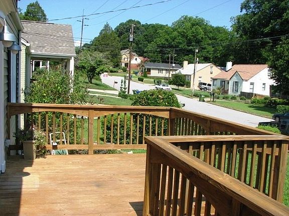 Oversized front deck overlooking sunny front yard.