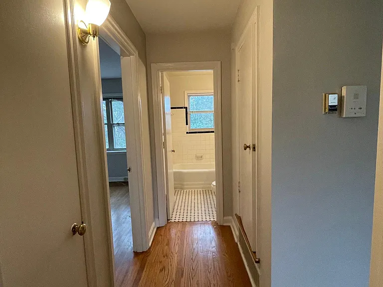 In bedroom looking down hall towards bedroom #2 and bathroom. Coat closet on the left and linen closet on the right.