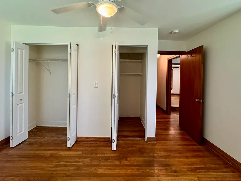Bedroom 1 with hardwood flooring; spacious closets.