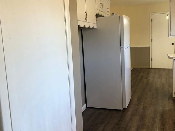 Pantry to left. Washer hook-up next (dryer hook-up is in garage). Extra space. Refrigerator is included in rent, can be removed if you have your own. Overhead storage cabinets above.