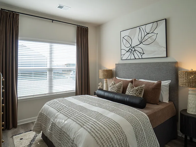 Secondary bedroom with queen size bed and large window letting in a ton of natural light.