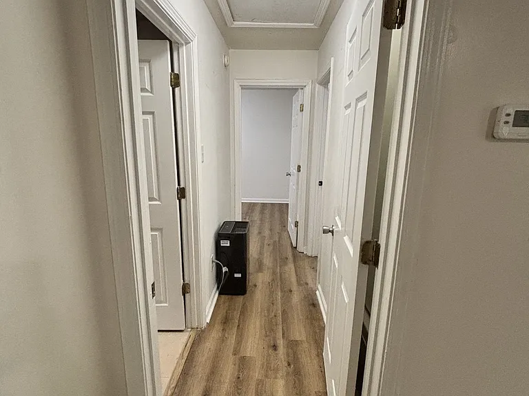 hallway to bedrooms. Hallway has a door that closes for privacy.