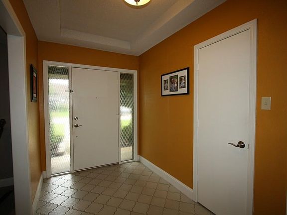Tiled foyer with trey ceiling, updated lighting and hardware. Insulated front door also includes a s