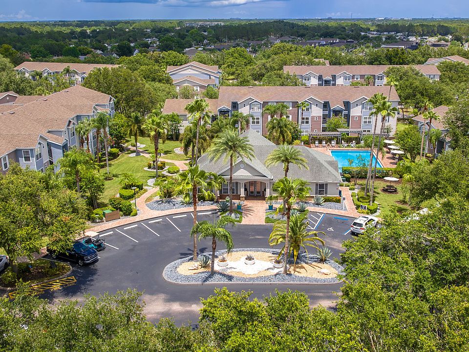 Discover the lush, resort-style layout of Ashton Chase Apartmentsfeaturing vibrant landscaping, a sparkling pool, and spacious apartment homes.