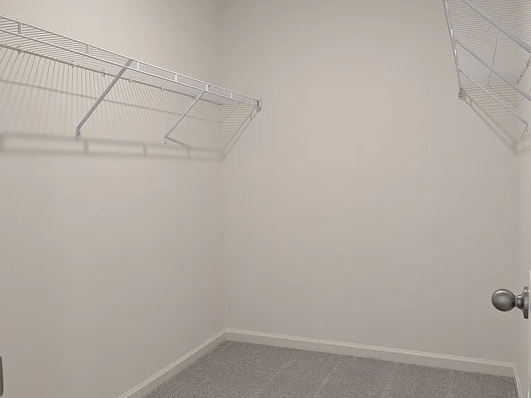 Primary bedroom walk-in closet