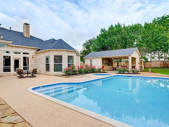 Relax in the beautiful backyard featuring pool, spa and covered patios