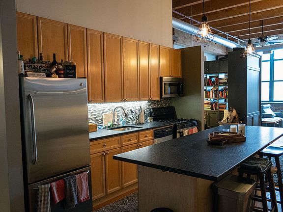 More of the kitchen, including a view of the living room windows