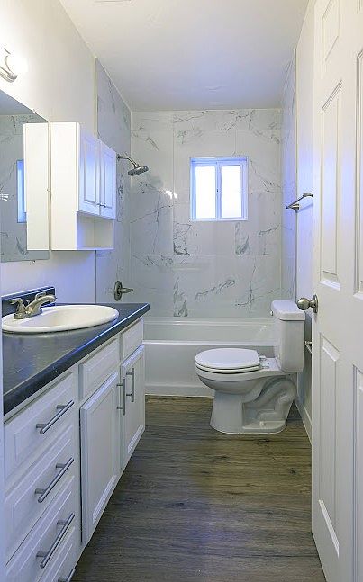 JUST REMODELED BATHROOM WITH NEW TILE AND NEW DEEP SOAKING TUB. NEW LIGHT GREY PLANK CERAMIC TILE 11/17/25. SEE NEXT PIC.