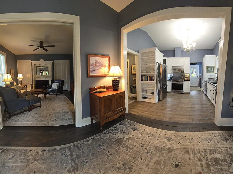 Panoramic view from back entrance of LR and Kitchen entrances to see space flow.