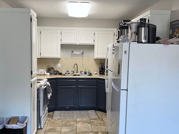 Kitchen with 2 refrigerators and new cabinet paint