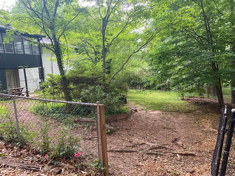 Not shown is the surrounding wooden fence. Here you can see the separate entrance to the downstairs living space.