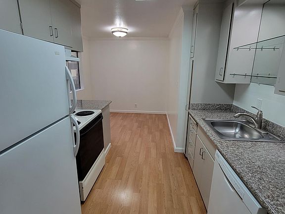 Eat-in kitchen with laminated floor - taken from living room