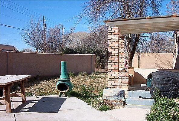 Covered Front Porch overlooking walled courtyard.