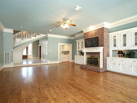 This view of the entry of the home, shows the tall door and decorative accent windows that allow plenty of natural light.