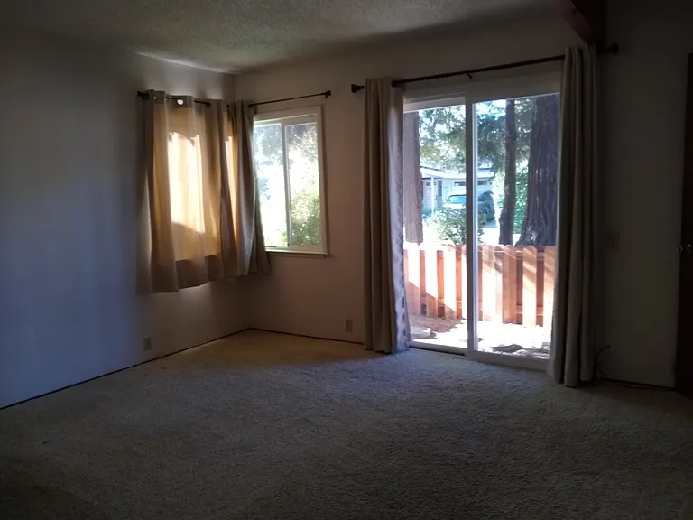 Primary bedroom with slider to front patio area.