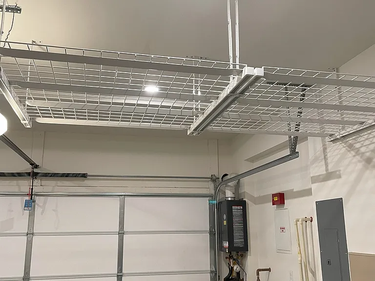 2 car garage with storage racks. Tankless water heater and water softener