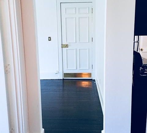 Front door to condo front interior stairwell.