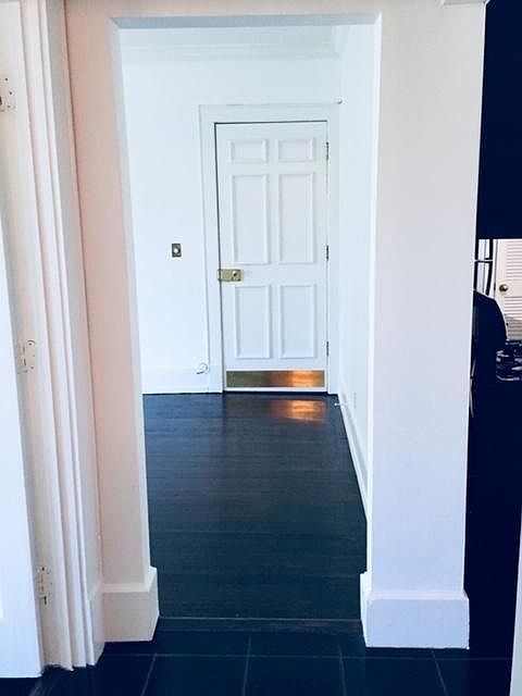 Front door to condo front interior stairwell.