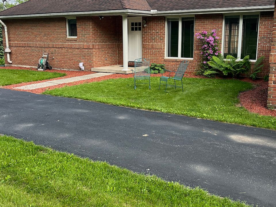 Entrance showing yard and parking space
