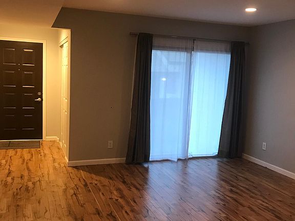 Living room, patio entrance, and front door