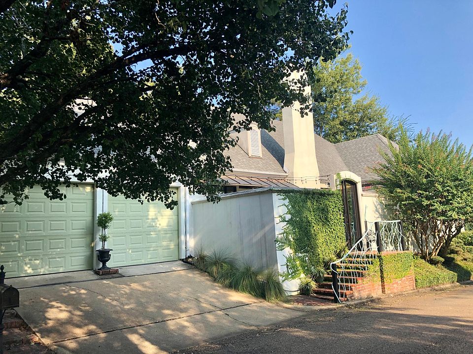 Front of home with courtyard entry and double garage.