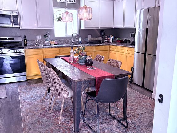 The kitchen comfortably fits a 6-chair table