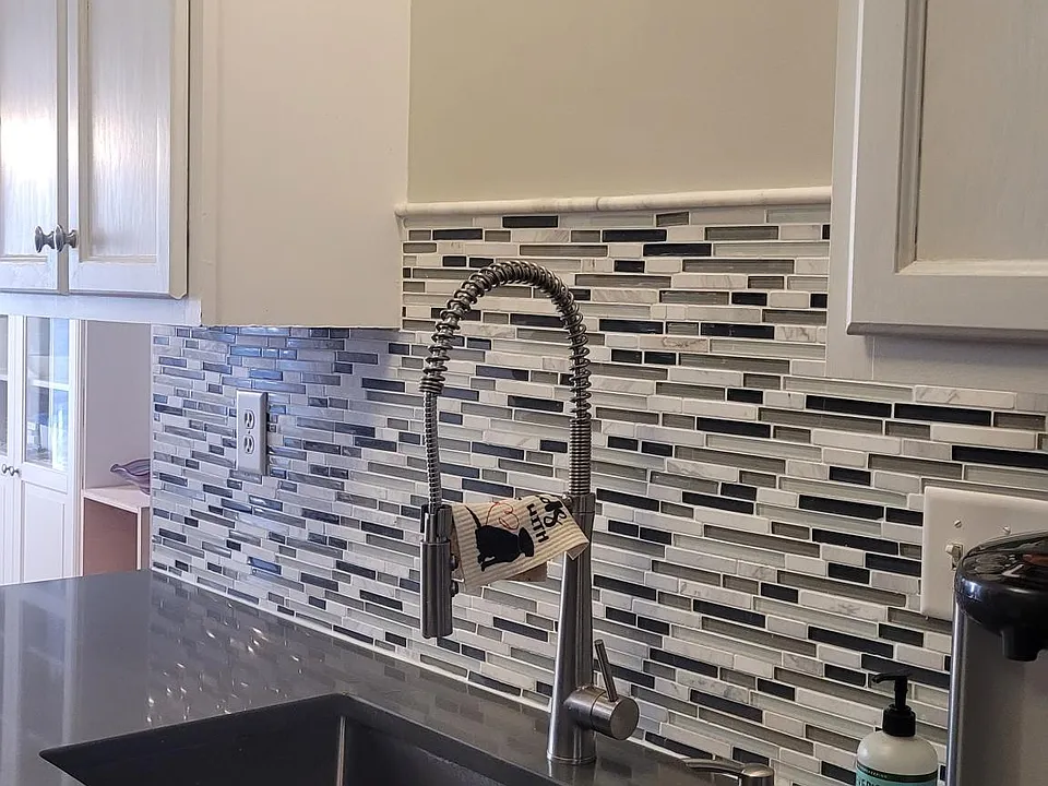 Quartz counter tops and trendy pull down industrial faucet.
