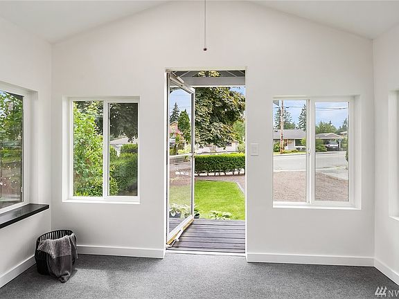 View from the mudroom towards the front entry. Bright and cheery with vaulted ceilings and lots of windows!!