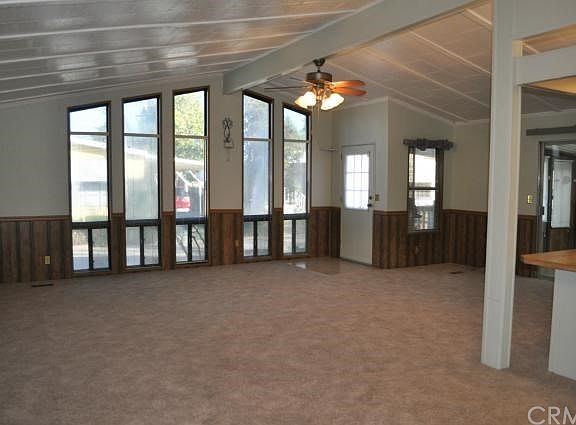 Large family room with floor to ceiling windows and extra workspace area.