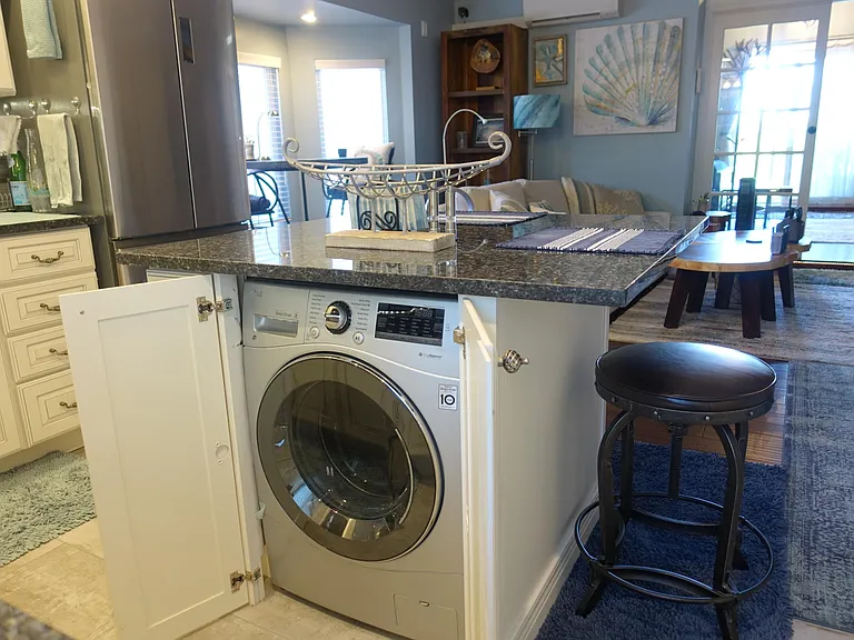 Washer/dryer combo brilliantly hidden under the island.
