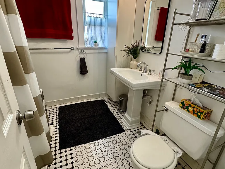 shared bath features two full shelves in cabinet for your toiletries. toilet features bidet.