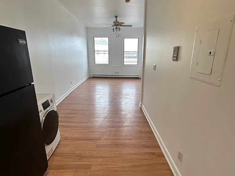 shiny hardwod floors of kitchen area into living room