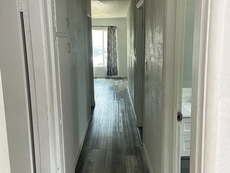 Hallway to 3 bedrooms and 2 bathrooms