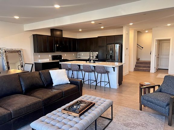 Four stools at island. Refrigerator, microwave, gas stove and oven, dishwasher and plenty of lighting throughout.