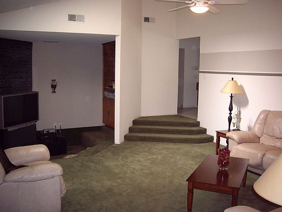 View of family room from kitchen (stairway to front entry foyer).