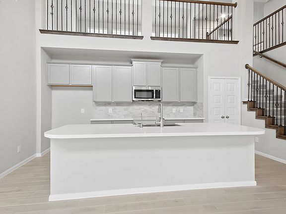 Palatial kitchen with custom cabinets spacious island