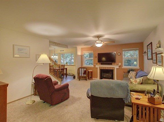 Entering the foyer we come to the living room.  Gas fireplace in the foreground.  Office and den to my left - master bedroom to my right.  The TV stays and it pulls out from the wall where there is storage.