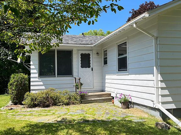 Rear yard stone patio. Exterior door into sunroom.