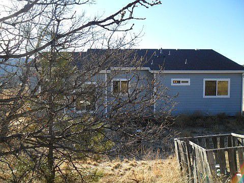 View of back yard & rear view of home