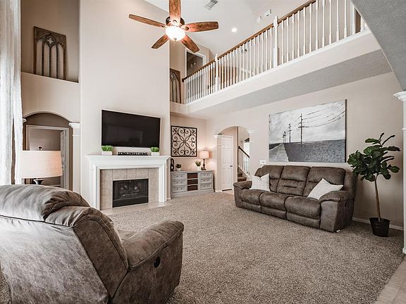 This cozy family room is light and bright and centered by the fireplace