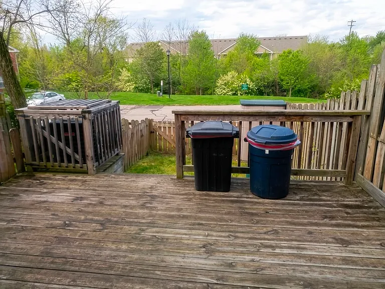 Deck. AC unit, trash cans, garden tools shelf
