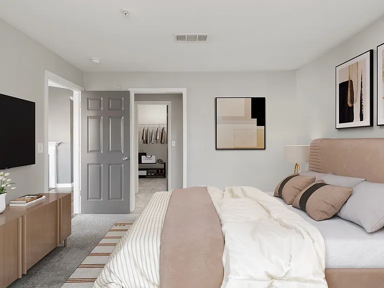 Renovated apartment bedroom setup with mounted TV and comfortable layout